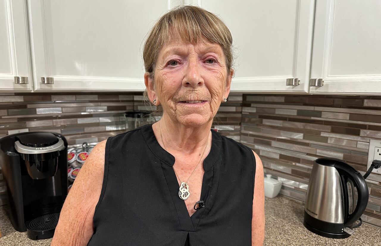 default-181 Woman standing in her kitchen.