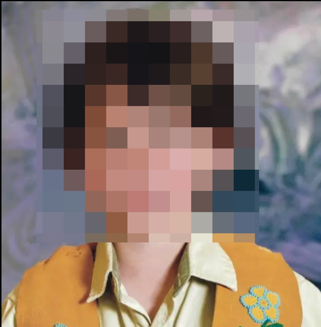 A blurred portrait of a child.