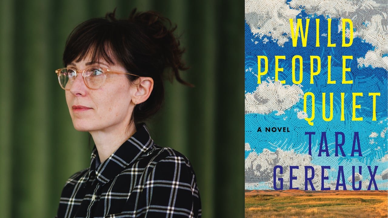 default-382 A woman with her hair in a bun and glasses, with a book cover depicting a beaded sky over a Saskatchewan plain.